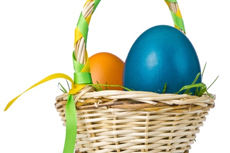 painted easter eggs in basket isolatedの写真素材