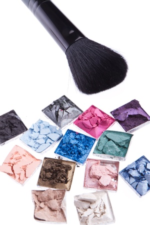 multicolored crushed eyeshadows with brush isolated on white backgroundの写真素材