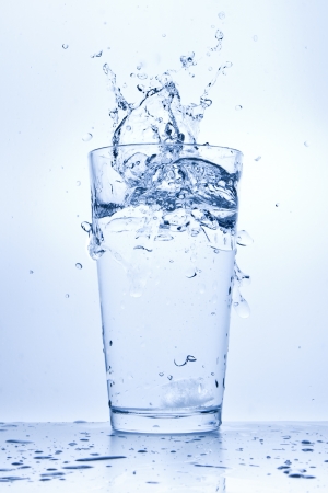 water splashing from glass isolated on white backgroundの写真素材