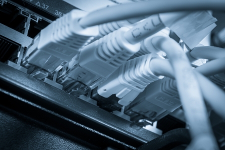 close-up of network hub and ethernet cablesの写真素材