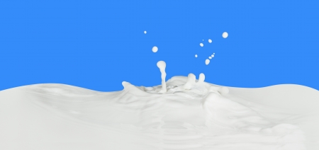 splashing milk isolated on blue backgroundの写真素材