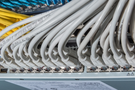 network cables connected to switch - closeup of data center hardwareの写真素材