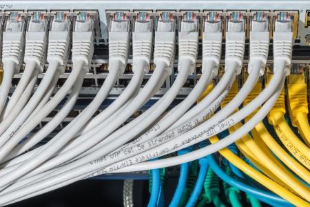 network cables connected to switch - closeup of data center hardwareの写真素材