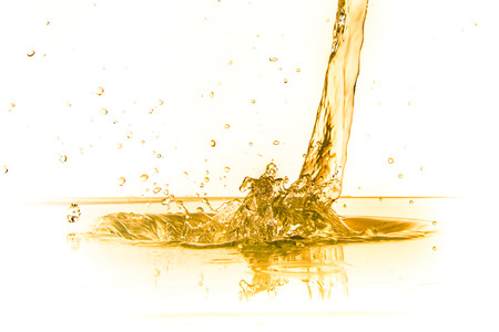 orange juice splash isolated on white backgroundの写真素材