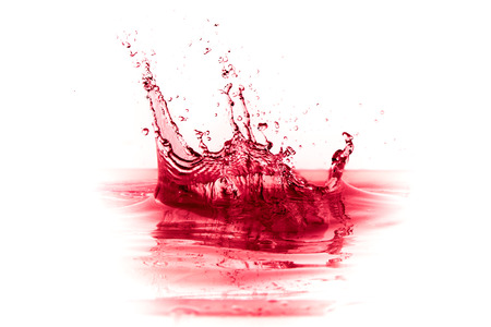 red wine splash isolated on white backgroundの写真素材