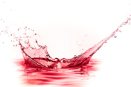 red wine splash isolated on white の写真素材
