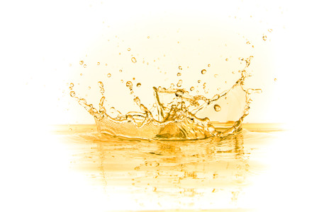 orange juice splash isolated on white backgroundの写真素材