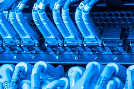 network cables connected to switch - closeup of data center hardwareの写真素材