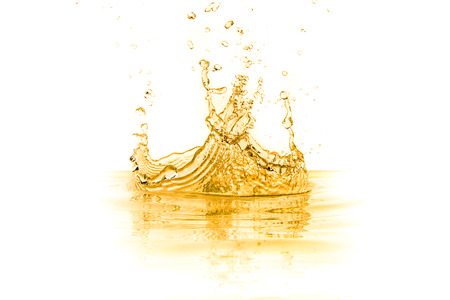orange juice splash isolated on white backgroundの写真素材