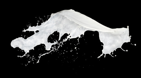 milk splash isolated on black backgroundの写真素材