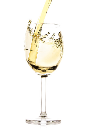 white wine splash isolated on whiteの写真素材