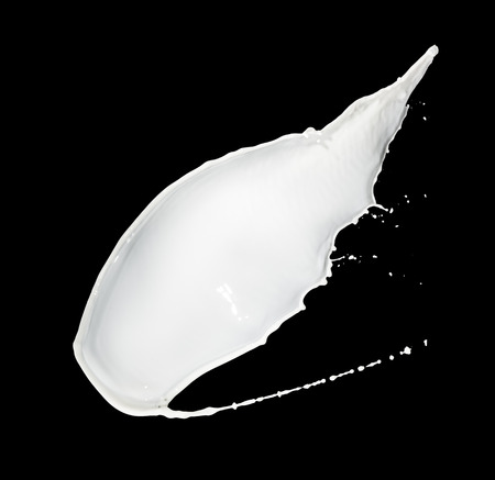 milk splash isolated on black backgroundの写真素材