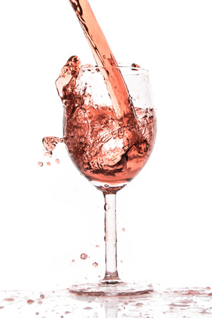 rose wine splashing on white backgroundの写真素材