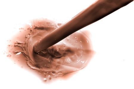 pouring chocolate drink, isolated on white backgroundの写真素材