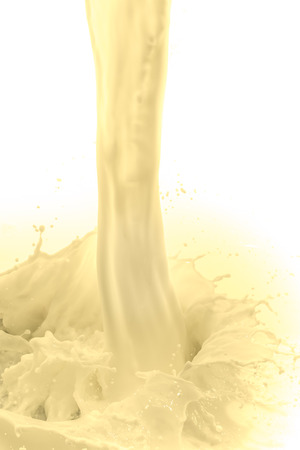 pouring vanilla flavored milk on white backgroundの写真素材