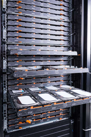 Cluster of hard drives inside open tray - a cloud data storage concept