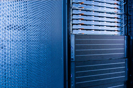 server rack with uncovered data storage arrays filled with hard drives - internet cloud provider conceptの写真素材