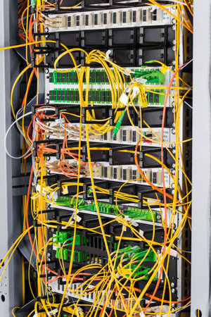 detail of server rack with fiber optic cables attached to front panel switch ports