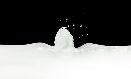 splashing milk isolated on black backgroundの写真素材