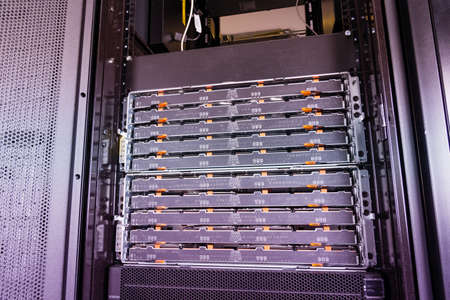 detail of large number of cables tied together connecting racks inside server room