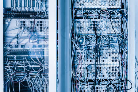 server room rack with tangled network cables creating messy untidy network system