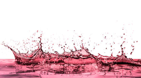 splashing red wine on white backgroundの写真素材