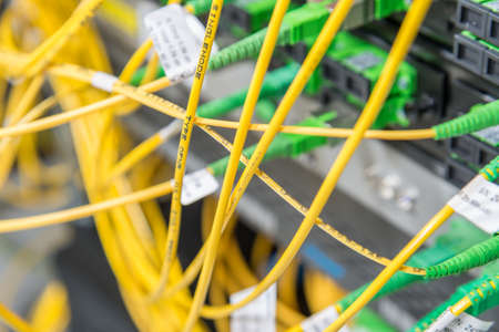 server with fiber optic  cables in data centerの写真素材