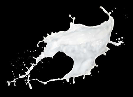 milk splash isolated on black backgroundの写真素材