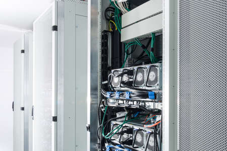 A row of racks with data storage hardware inside server room