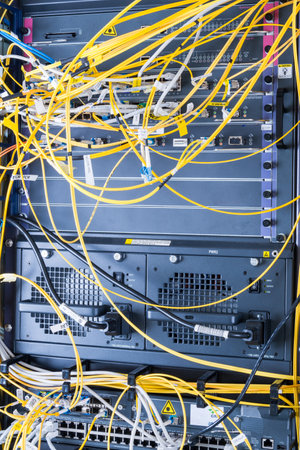 yellow fiber optic cables plugged in network switch