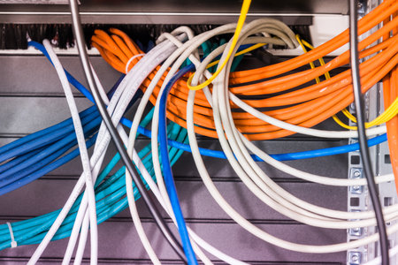 bunch of patch network cables sorted in rack cabinet, leading from patch panel in the server rack in the data center roomの写真素材