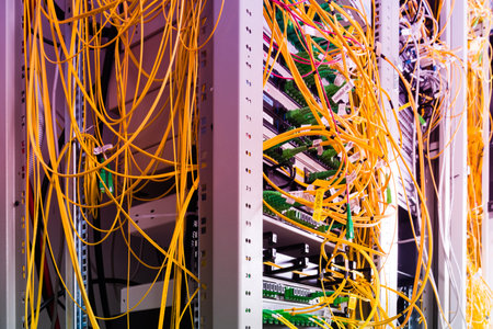 data center with bundle of fiber optics cables connected to data switchの写真素材