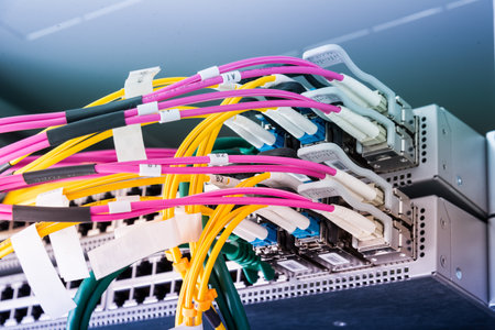 Fiber optic cables connected to an optic ports - data switch in internet data centerの写真素材