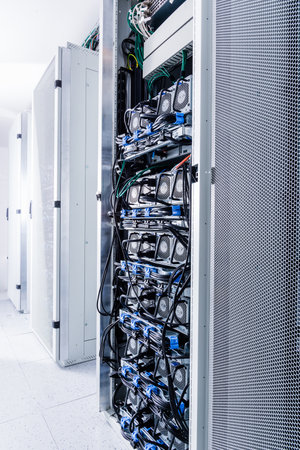 A row of racks with data storage hardware inside the server roomの写真素材