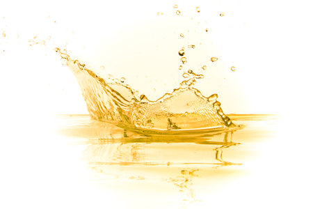 orange juice splash isolated on white backgroundの写真素材