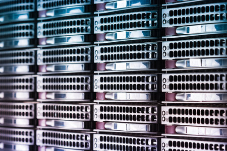 Row of hard drives serving as data storage inside server roomの写真素材