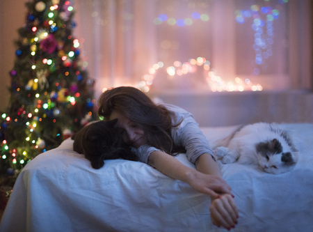 the girl is lying on the bed with the sealsの写真素材