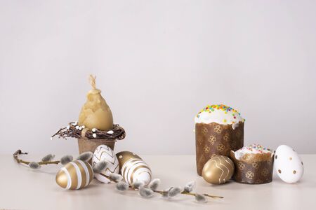 Easter still life with Easter cake, eggs and willow on a white background