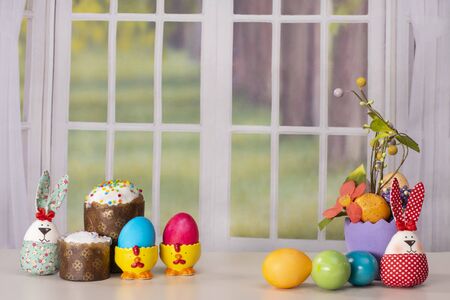 Easter still life with eggs and Easter cake on a window backgroundの写真素材