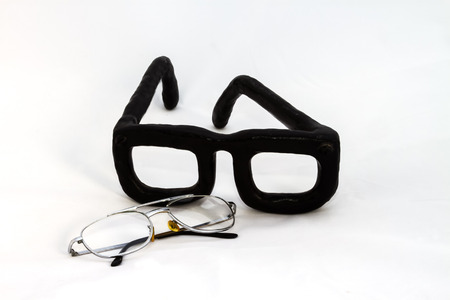 The big artificial eyeglasses compare with the real one.