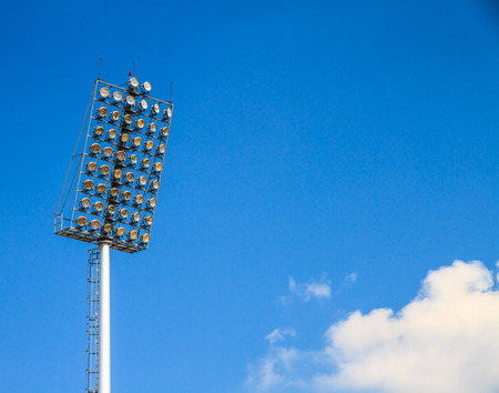 Lamp post over the sports stadium with blue sky background.
