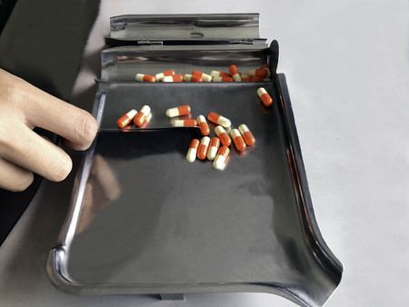 Pharmacist counts medications to patients.の写真素材
