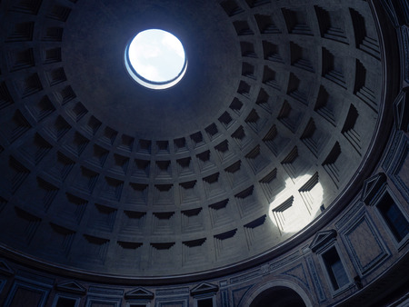 Sunlight passes through the hole in ceiling of Pantheon roman temple in Rome and creates a perfect circle on the wallの写真素材