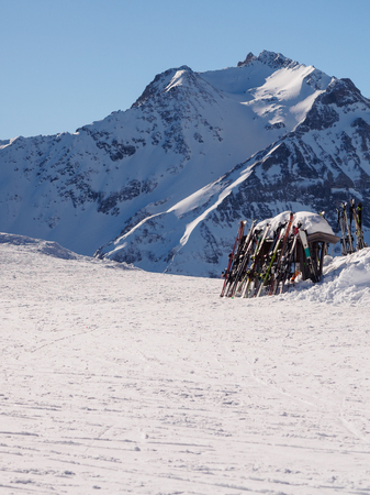 Stack of skis standing in front of snow peak in Mayrhofen, Austriaの写真素材
