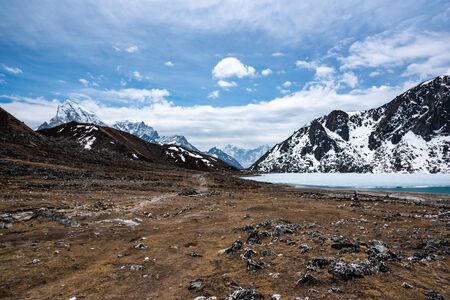 Second Gokyo lake partly frozen and Mount Cholatse in background, Nepal Himalaya mountains