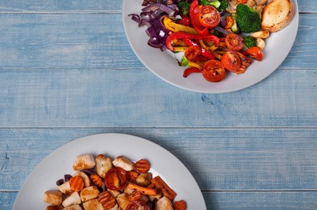 Grilled vegetables with chicken on wooden table. Top view. Copy space. Food backgroundの写真素材