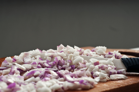 Chopped onions on a chopping board closeup. Copy space. Free space for textの写真素材