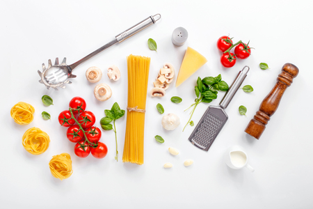 Fettuccine and spaghetti with ingredients for cooking pasta on a white background, top view. Flat layの写真素材