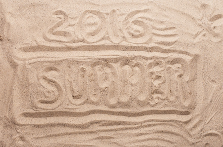 Inscription on the sand closeup - summer 2016の写真素材