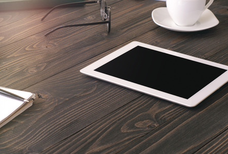 Office workplace with tablet on wooden desk.の写真素材